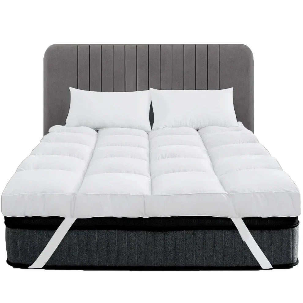 White 10cm thick mattress topper with corner straps on a bed
