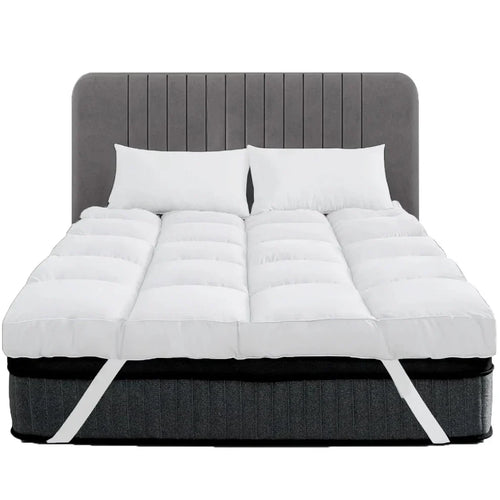 White 10cm thick mattress topper with corner straps on a bed